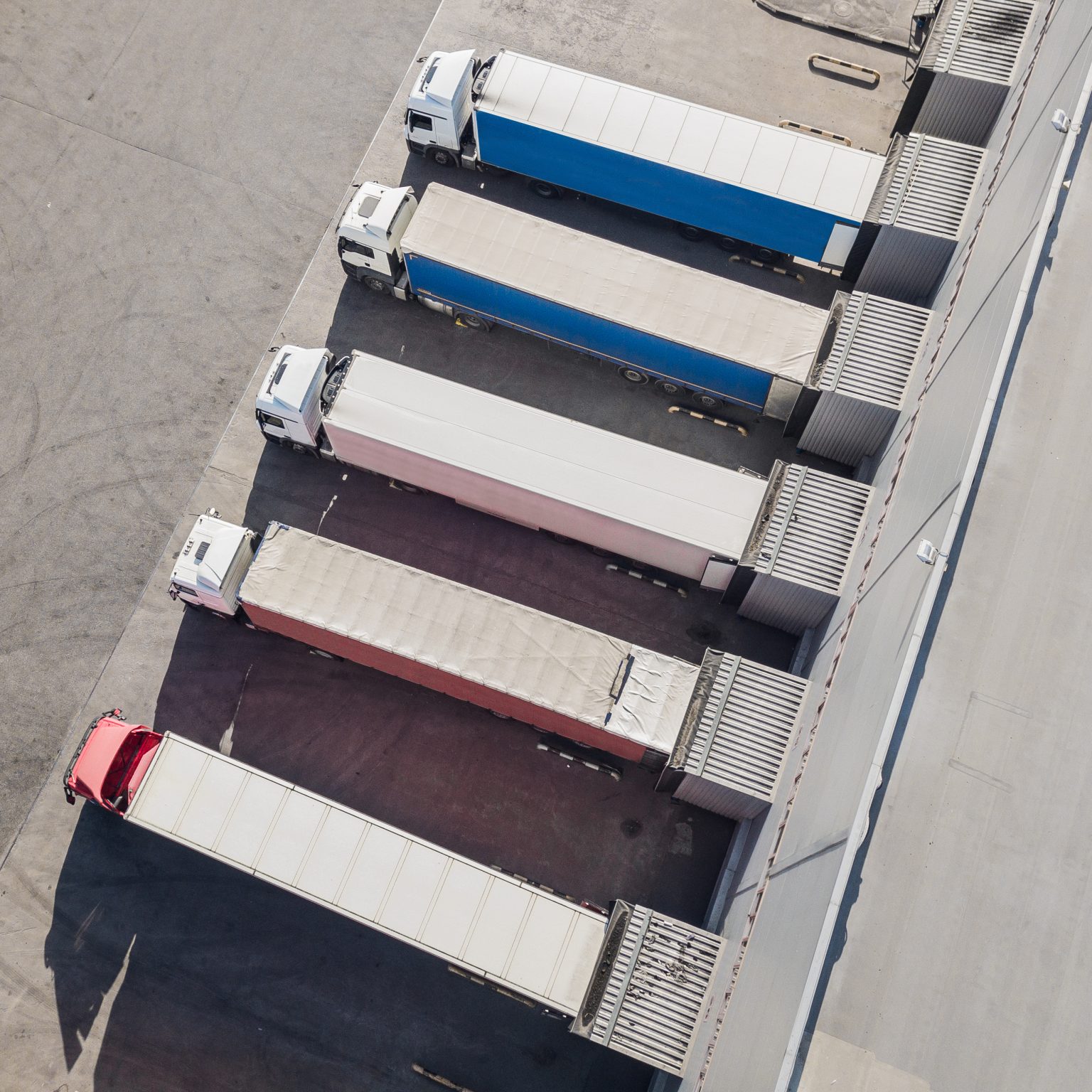 Auto & Vehicle Insurance trucks unloading in logostics center